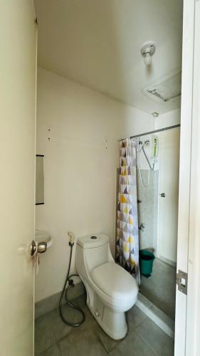 a bathroom with a toilet and a shower at Condo unit in Novaliches Quezon City near Caloocan City in Manila