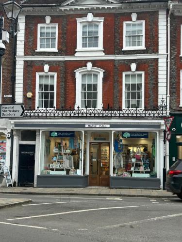 a store front of a brick building on a street at Single Room in Georgian Masionette in Blandford Forum