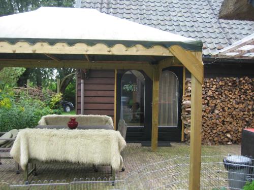 a gazebo with haycovered tables in a yard at The Atelier in Nijkerkerveen