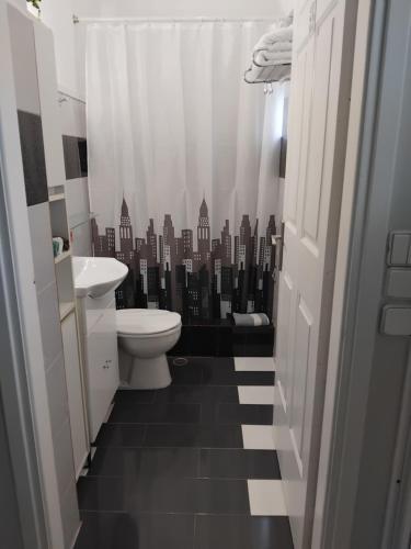 a bathroom with a toilet and a black and white city at G&G home 2 in Kalamata