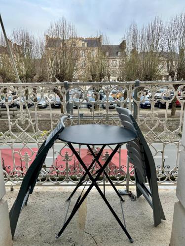 a table sitting on top of a balcony at Cit'Hotel le Challonge in Dinan