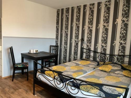 a bedroom with a bed and a table and a desk at Pension&Hostel Anna - Monteurzimmer -------- 10 minutes walk to Oktoberfest in Munich