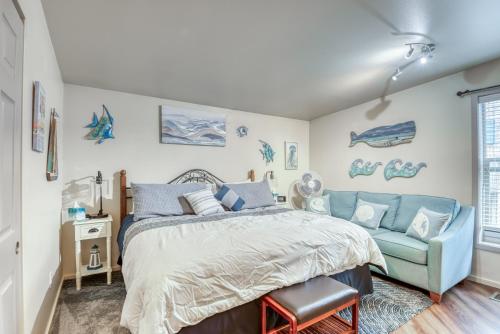 a bedroom with a bed and a blue couch at Luxury Oceanview Escape in Depoe Bay Book Your Stay at Tranquility Cove in Depoe Bay