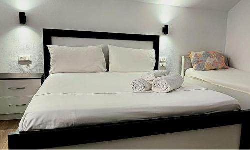 a bedroom with a bed with two towels on it at Guest House Pogradeci in Pogradec