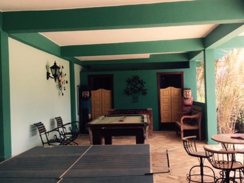 a patio with a ping pong table and chairs at Pousada Recanto Das Pedras in Tiradentes