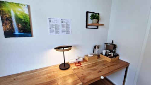 a wooden desk with a lamp on a wall at Mountainside Homestay in Spiez by Menbergs Harmony Homestay in Spiez