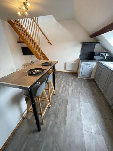 une petite cuisine avec une table en bois dans une pièce dans l'établissement Superbe studio à proximité du centre-ville, à Saint-Dié-des-Vosges