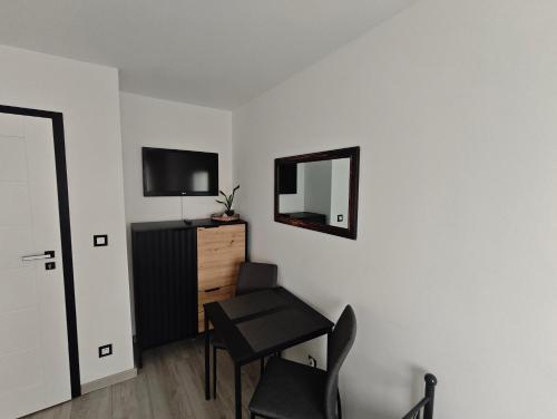 a room with a table and a mirror and a chair at Kraken Apart in Kołobrzeg