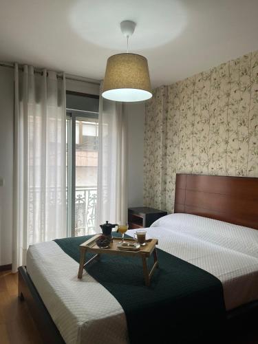 a bedroom with two beds and a table in it at PISO Bueu Playa in Bueu