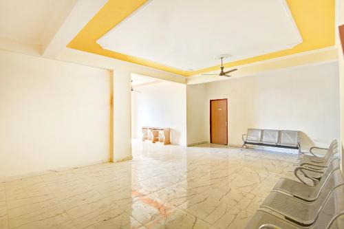 an empty room with chairs and a ceiling at HOME 78802 Balaji Bhawan Jhajra in Dehradun