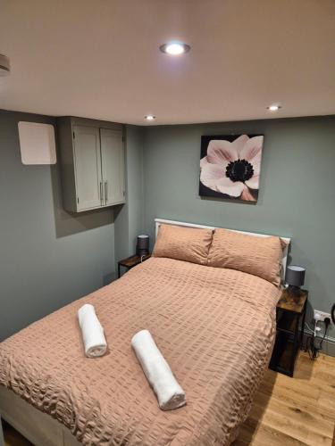 a bedroom with a bed with two towels on it at Charming 1 bed Peak District Barn Conversion in Foolow