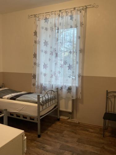 a bedroom with a bed and a window at Pension&Hostel Anna - Monteurzimmer -------- 10 minutes walk to Oktoberfest in Munich