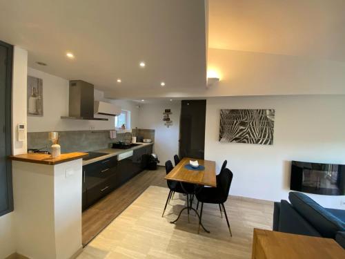 une cuisine et un salon avec une table et des chaises dans l'établissement Le grand Castille, à Uzès