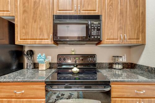 a kitchen with a stove and a microwave at Southern #2055 Mesa in Mesa