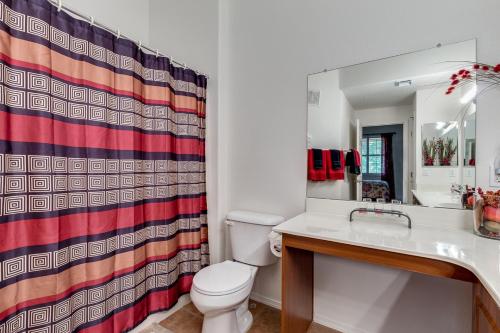 a bathroom with a toilet and a shower curtain at Southern #2055 Mesa in Mesa