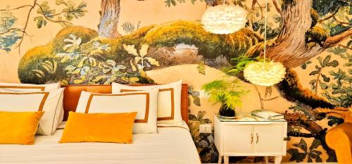 a bedroom with a bed with a wall mural at Napoli Tree - Lungomare in Naples