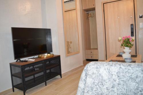 a living room with a flat screen tv on a stand at The loft heaven in Katerini