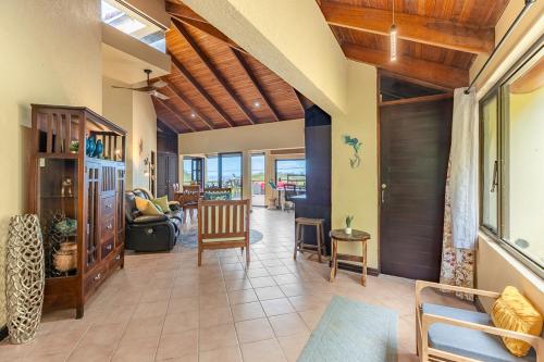 a living room with a table and chairs at Villa Sunset - Your Sunshine Escape! in Ocotal