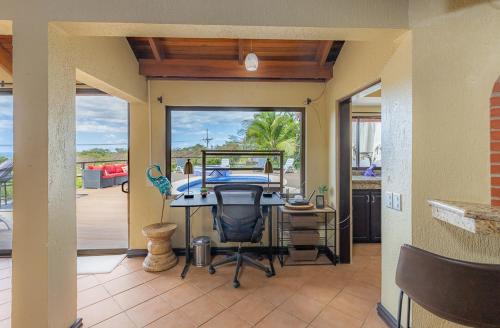a dining room with a table and a view of the ocean at Villa Sunset - Your Sunshine Escape! in Ocotal