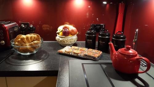 a kitchen counter with a table with a tea kettle and food at Lochnagar Guest House in Aberdeen