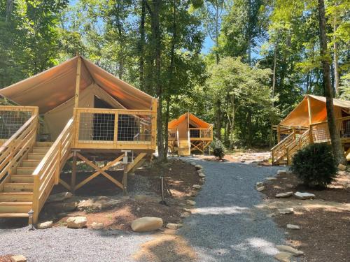a group of huts in the woods at Outdoor Adventure Retreats - Wilderness Cove Campground in Saluda