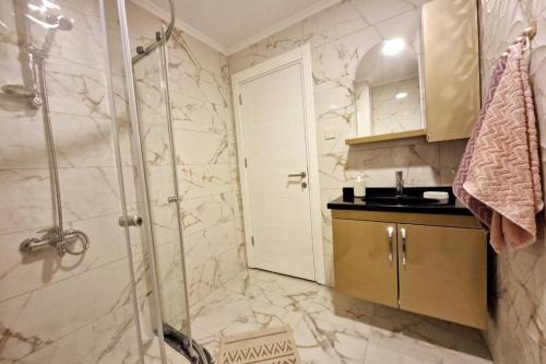 a bathroom with a shower and a sink at Sunny escape Holiday apartment in İskele