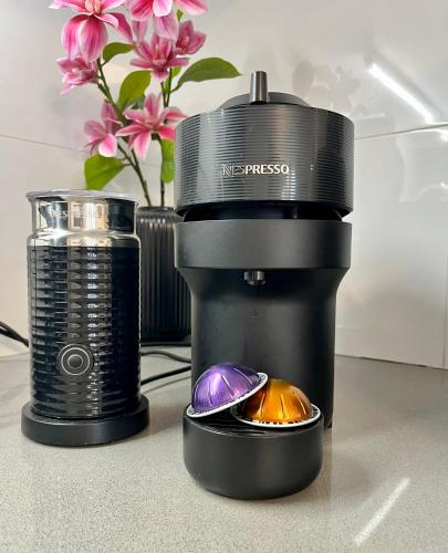a camera sitting next to a coffee cup and a lens at Lovely New Private Duplex in Prime City Center location in Jerusalem