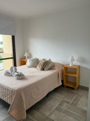 a bedroom with a bed with a teddy bear on it at Cba Rent in Córdoba