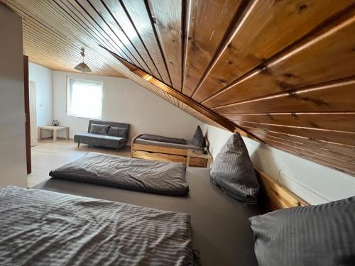 a room with two beds and a couch in it at Reiheneckhaus mit Garten und Terasse in Tettnang