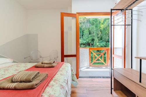 En eller flere senge i et værelse på Lindo Apto no Centro de Santo Antonio do Pinhal/SP