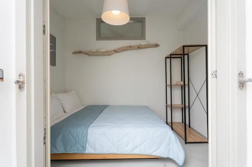 a bedroom with a bed and a mirror at ILIOS new 2bd house in Naousa in Naousa