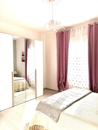 a bedroom with a bed and a mirror at Stefy's House in Scalea