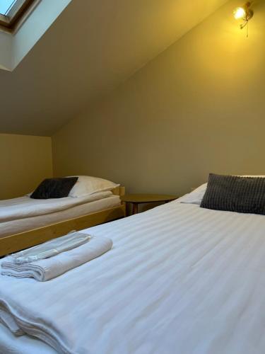 two beds in a room with towels on them at Pokoje przy Dworcu in Przemyśl
