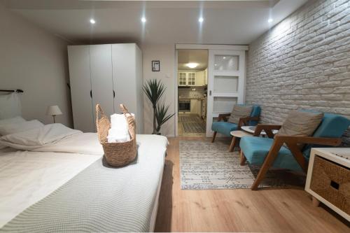 a bedroom with a bed and a living room at Cozy Haven in Belgrade