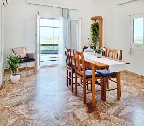 a dining room with a table and chairs at Mare Nostrum in Koutsounari