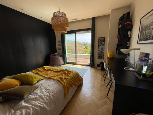 une chambre avec un lit et un bureau avec une fenêtre dans l'établissement House with pool, à Marseille