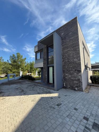 a brick building with a driveway in front of it at Canyon Villa Göynük Kemer Antalya with Pool in Antalya