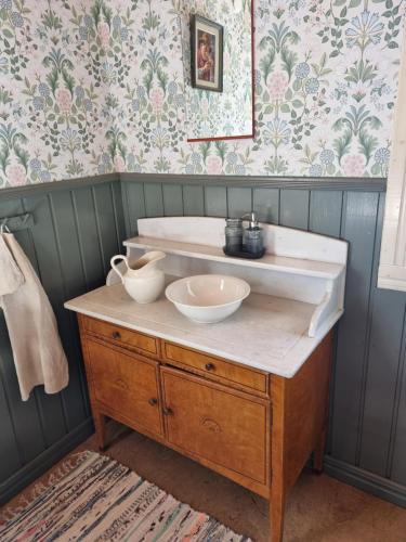 a bathroom with a sink with two bowls on it at Skogsgläntan in Åshuvud