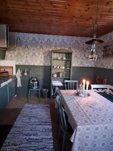 a kitchen with a table with candles on it at Skogsgläntan in Åshuvud