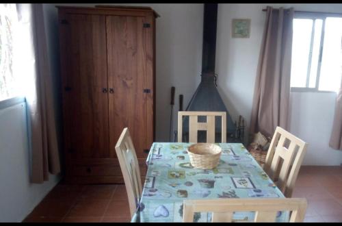 a dining room with a table and four chairs at Reconquista Villa Serrana in Villa Serrana