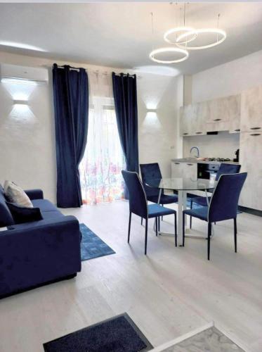 a living room with a couch and a table and chairs at Stefy's House in Scalea