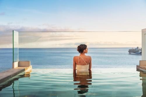a woman sitting in a pool of water at Casa Mar Dream House Old Town Funchal in Funchal