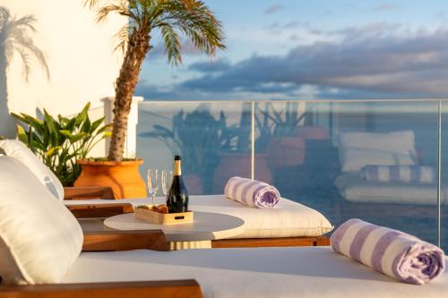 a room with a table with a bottle of wine at Casa Mar Dream House Old Town Funchal in Funchal