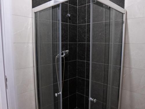 a shower with a glass door in a bathroom at Casabeleza Cape Verde in Assomada