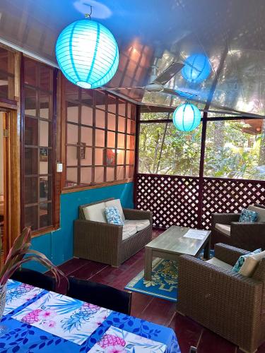 a living room with chairs and a table and lights at Las Palomas Villas in Cocles