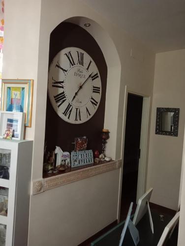 a large clock on a wall in a room at Nicolhouse in Triggiano