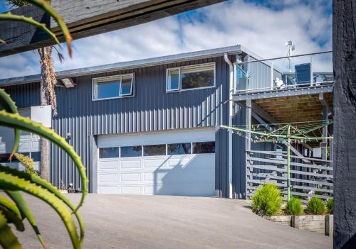 a house with a garage and a balcony at Mariri Heights Tasman in Upper Moutere