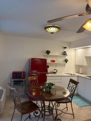 a kitchen with a table and chairs and a red refrigerator at Charming and Spacious Studio in Clearwater Beach