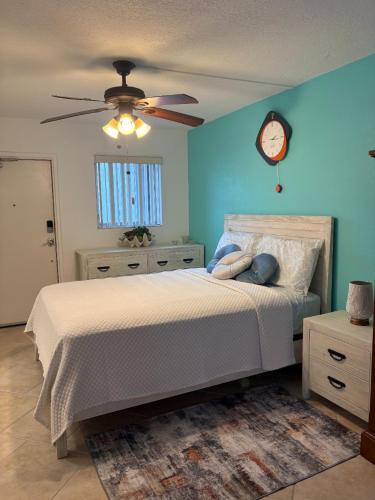 a bedroom with a bed and a clock on the wall at Charming and Spacious Studio in Clearwater Beach