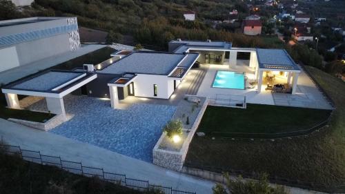 an aerial view of a house with a swimming pool at Alta Vista residence&spa in Mostar